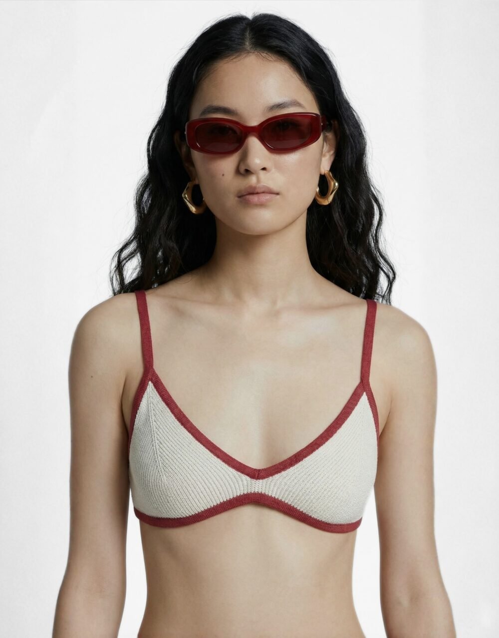A striking crimson set with bold pleated palazzos and a minimalist contrast-trim bralette