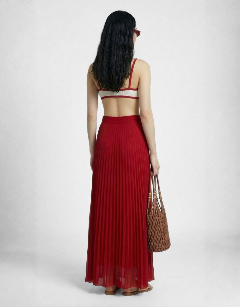 A striking crimson set with bold pleated palazzos and a minimalist contrast-trim bralette
