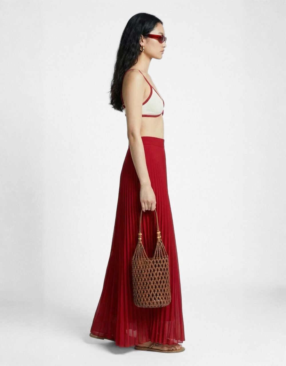 A striking crimson set with bold pleated palazzos and a minimalist contrast-trim bralette