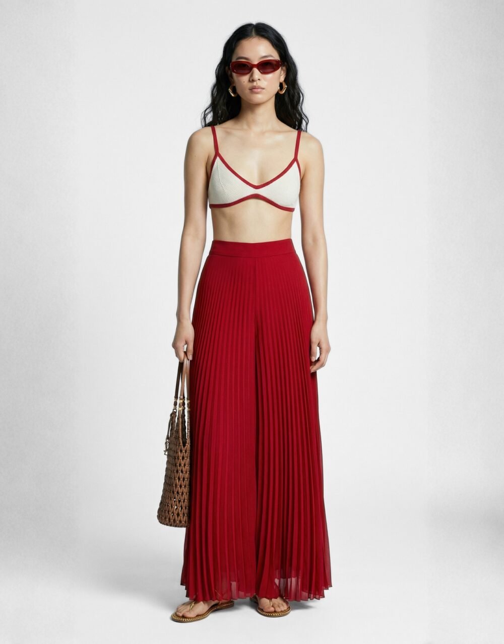 A striking crimson set with bold pleated palazzos and a minimalist contrast-trim bralette