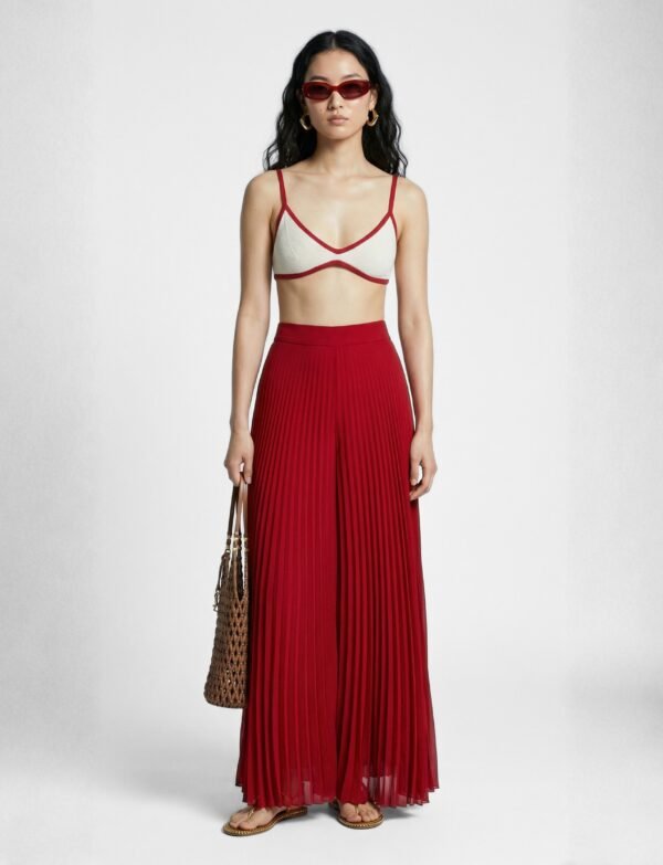 A striking crimson set with bold pleated palazzos and a minimalist contrast-trim bralette