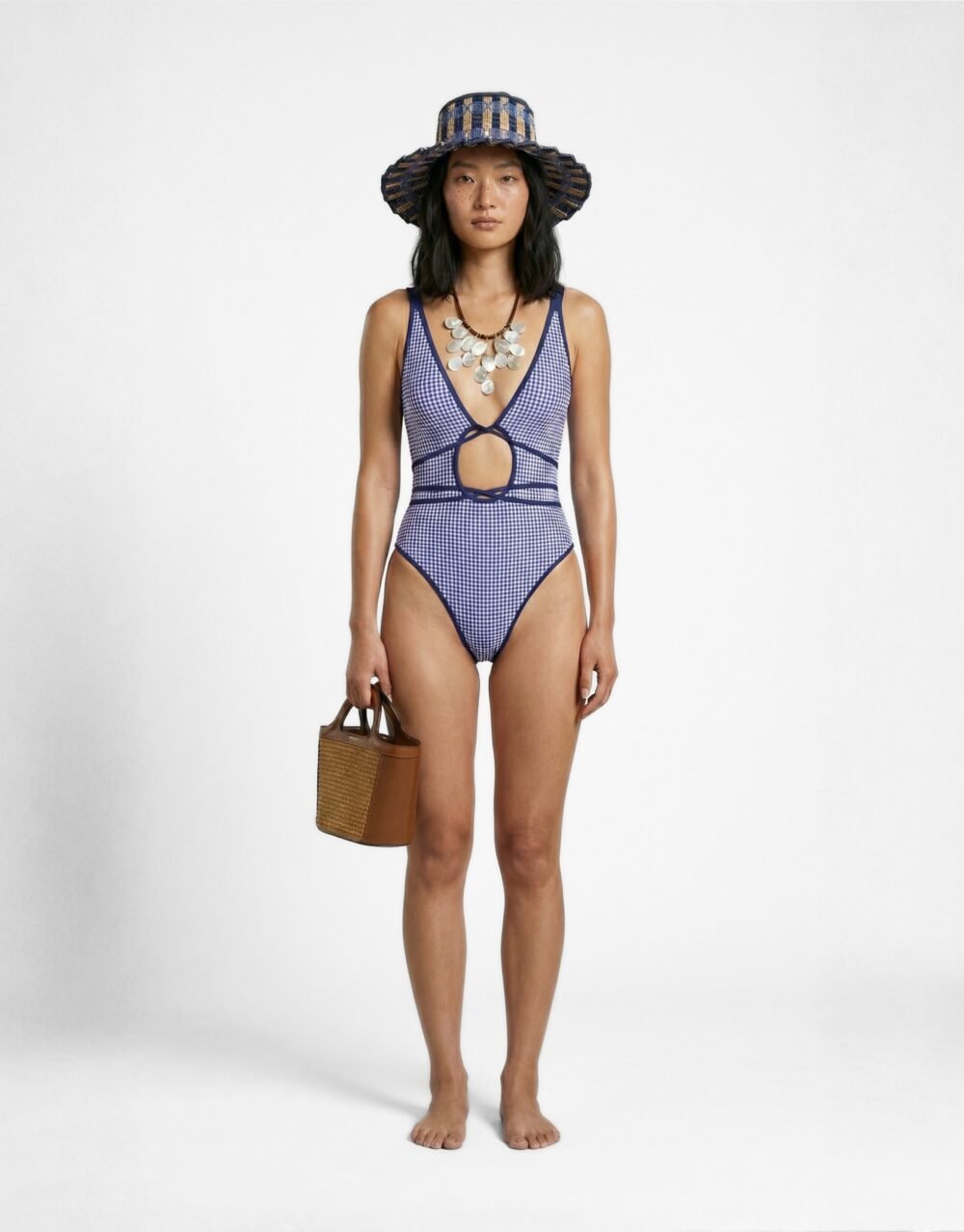 Gingham-print one-piece with front cutout, high-leg cut, and crossover strap detailing
