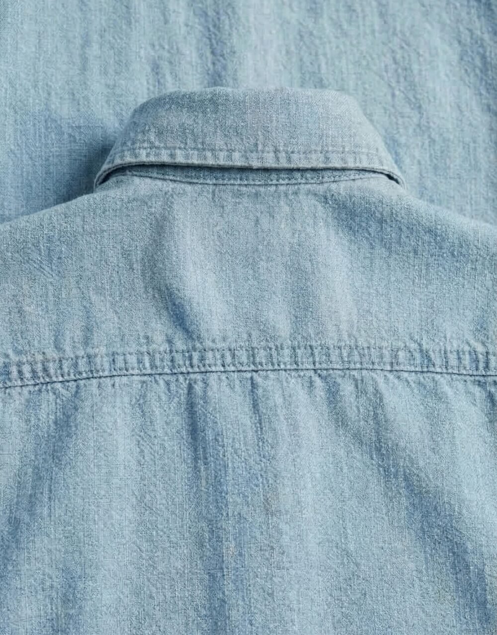 Slim-fit button-down shirt paired with pleated trousers in a refined, modern smart-casual style
