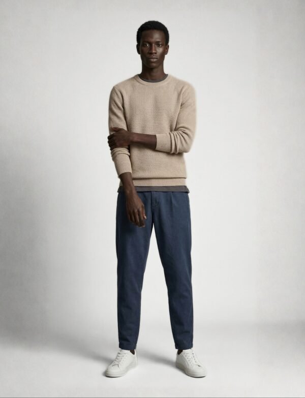 Textured Beige Knit Sweater with Relaxed Blue Trousers and Clean White Sneakers