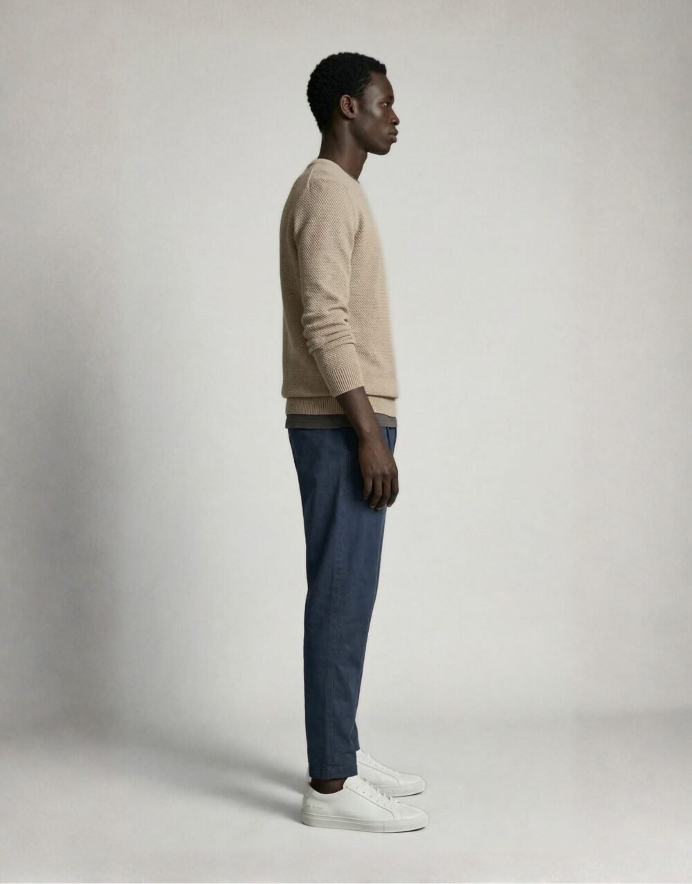 Textured Beige Knit Sweater with Relaxed Blue Trousers and Clean White Sneakers